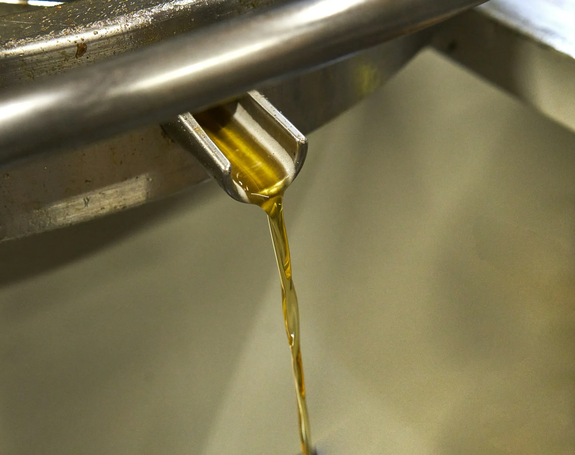 Fresh motor oil pouring in a smooth golden stream