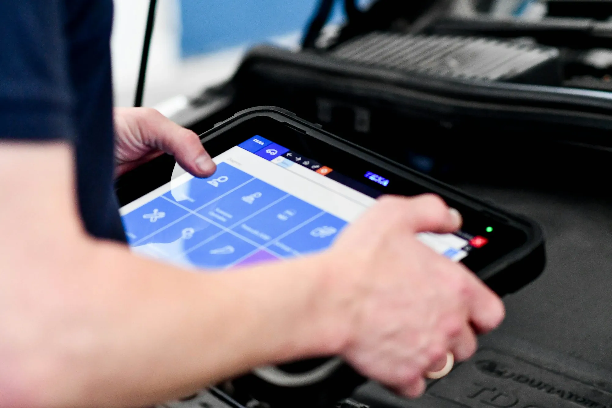 Mechanic reading live engine data on a tablet scan tool