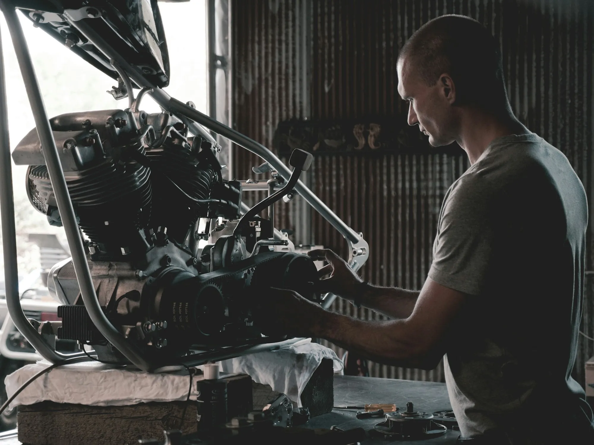 Mechanic working on an engine at a bench in a workshop